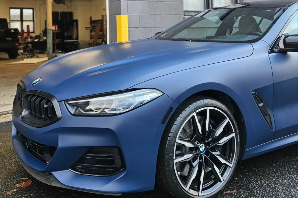 Front side view of matte blue BMW with glossy ceramic coating