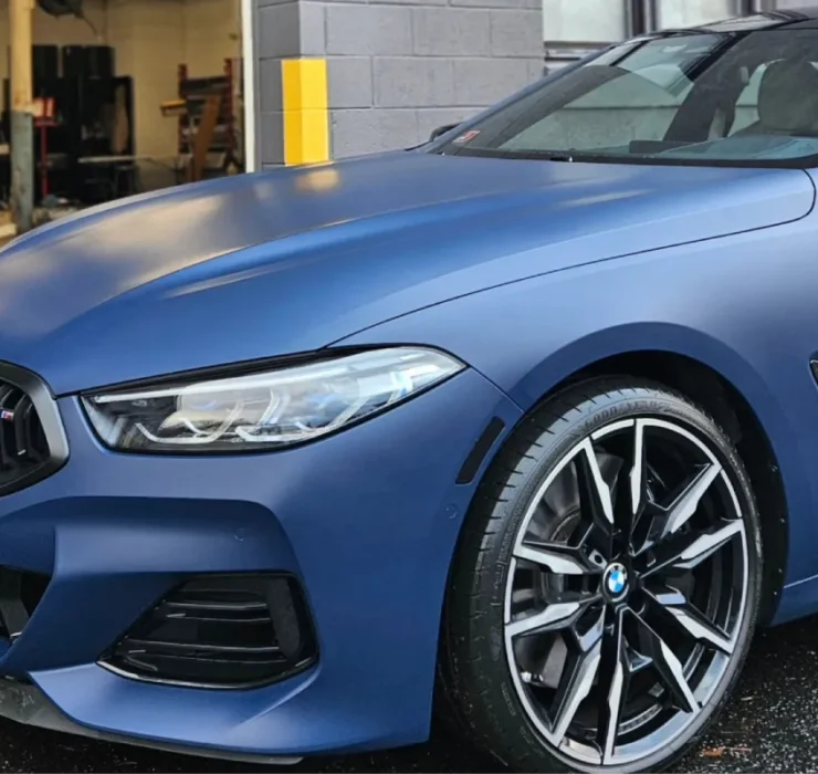Front side view of matte blue BMW with glossy ceramic coating