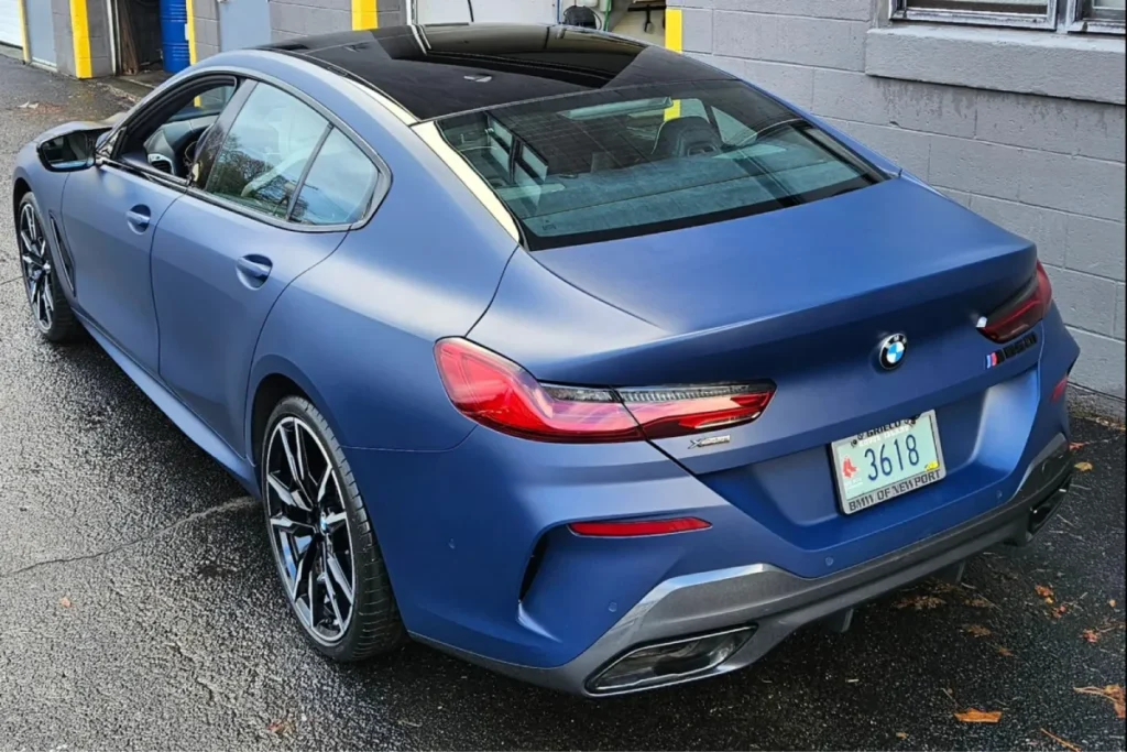 Matte blue BMW sedan rear view with ceramic coating finish
