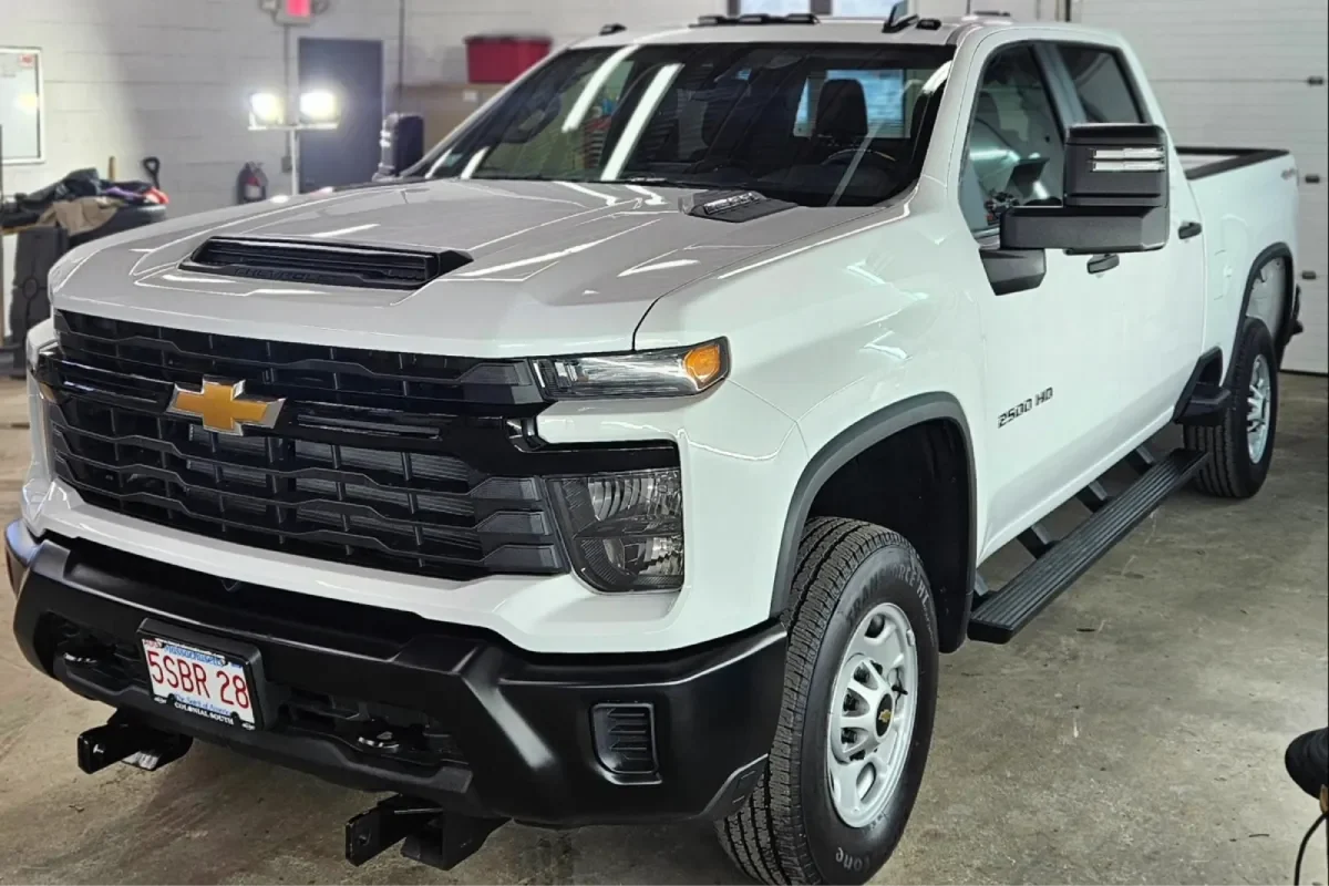 White Chevrolet Silverado 2500 HD truck in detailing shop