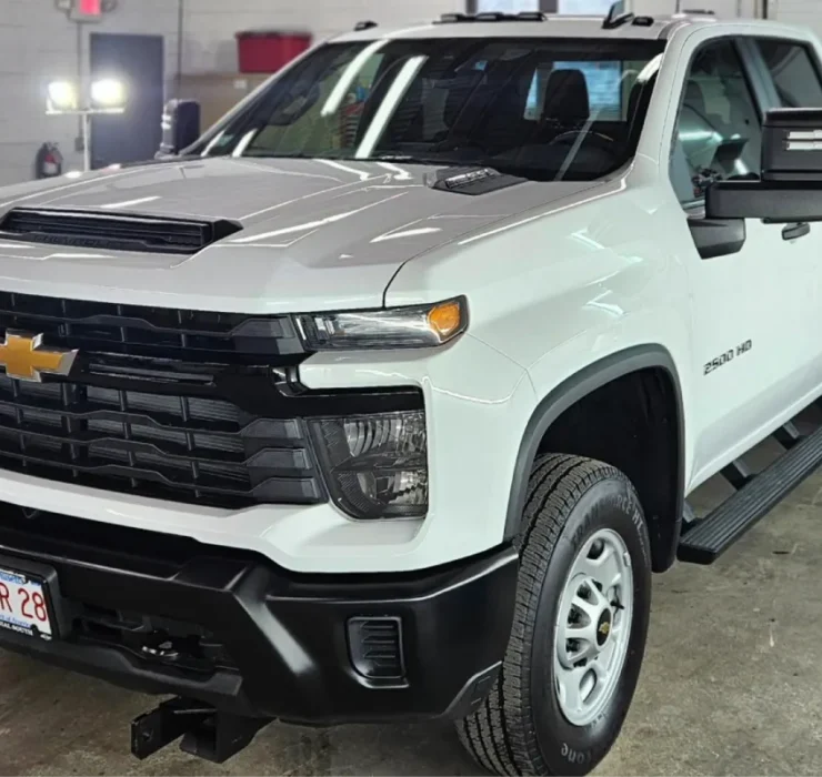 White Chevrolet Silverado 2500 HD truck in detailing shop
