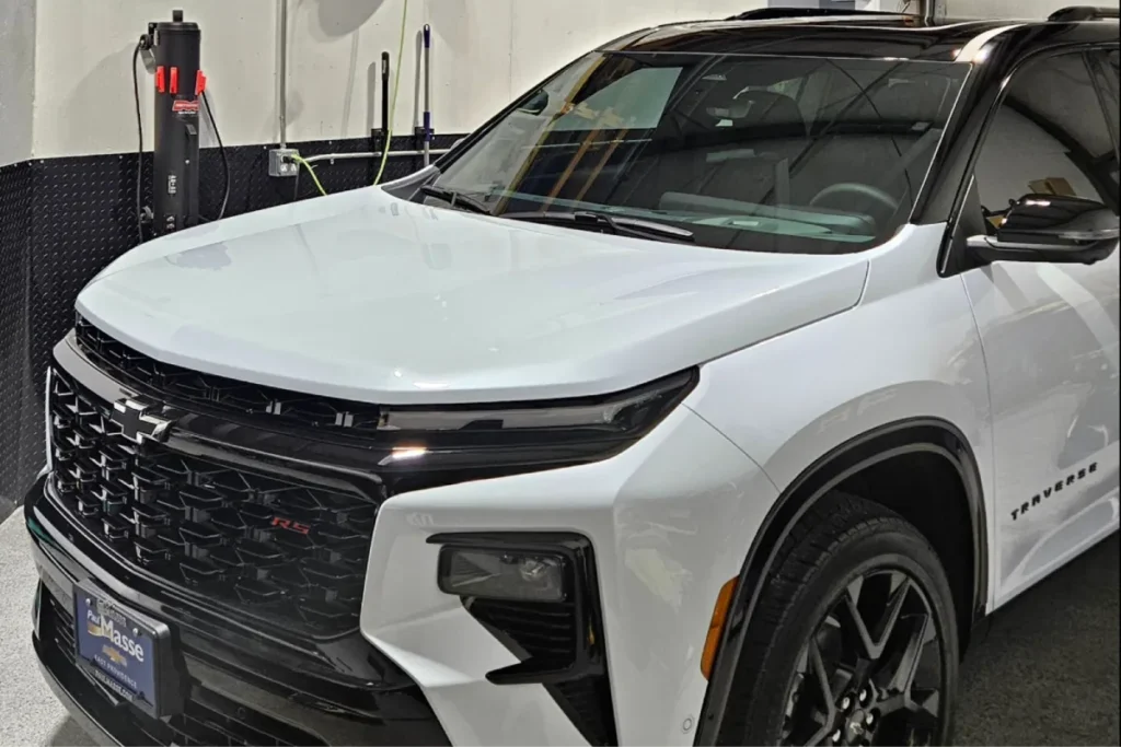 A close-up shot of the white Chevrolet Traverse RS with black accents and tinted windows.