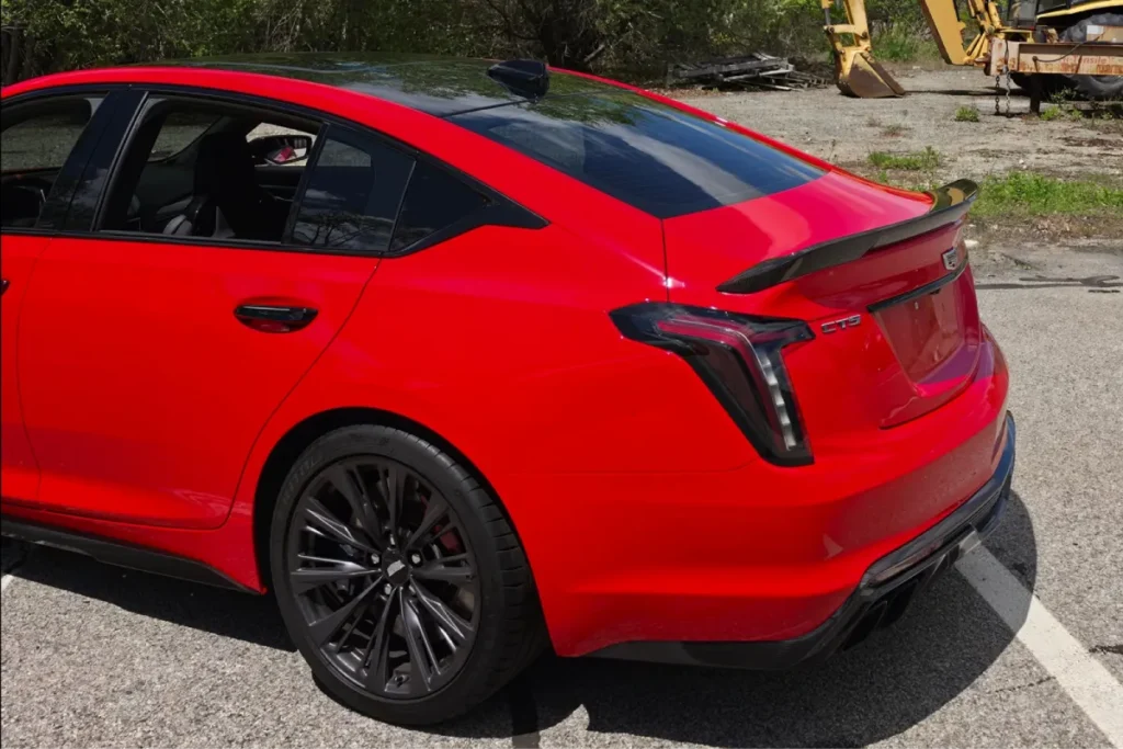 Red Cadillac CT5 with paint protection film on rear panels.
